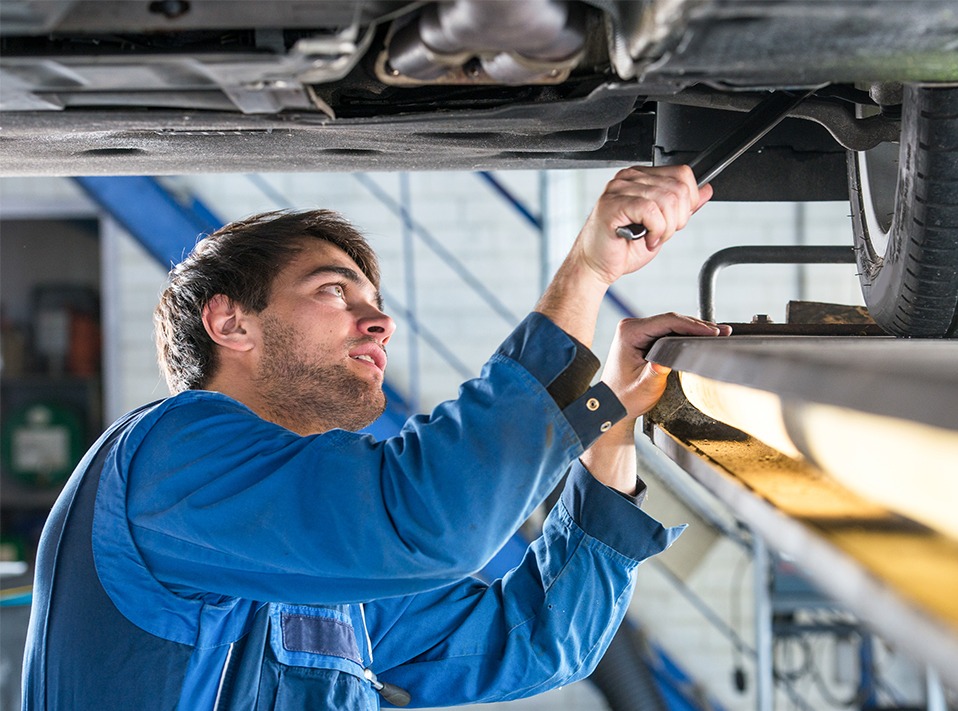 Mechanic looking underneath a vehicle - Vehicle Repairs Lingfield