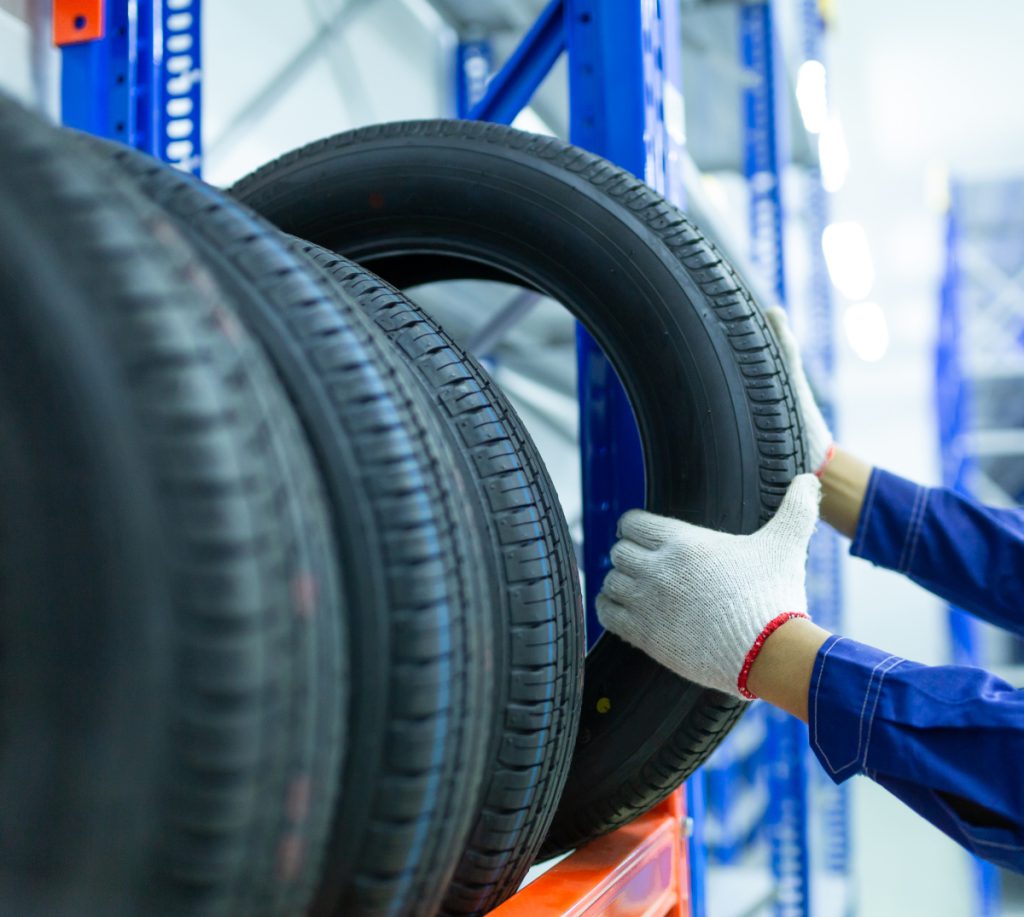 Mechanic taking out a tyre from stock - Tyres Lingfield